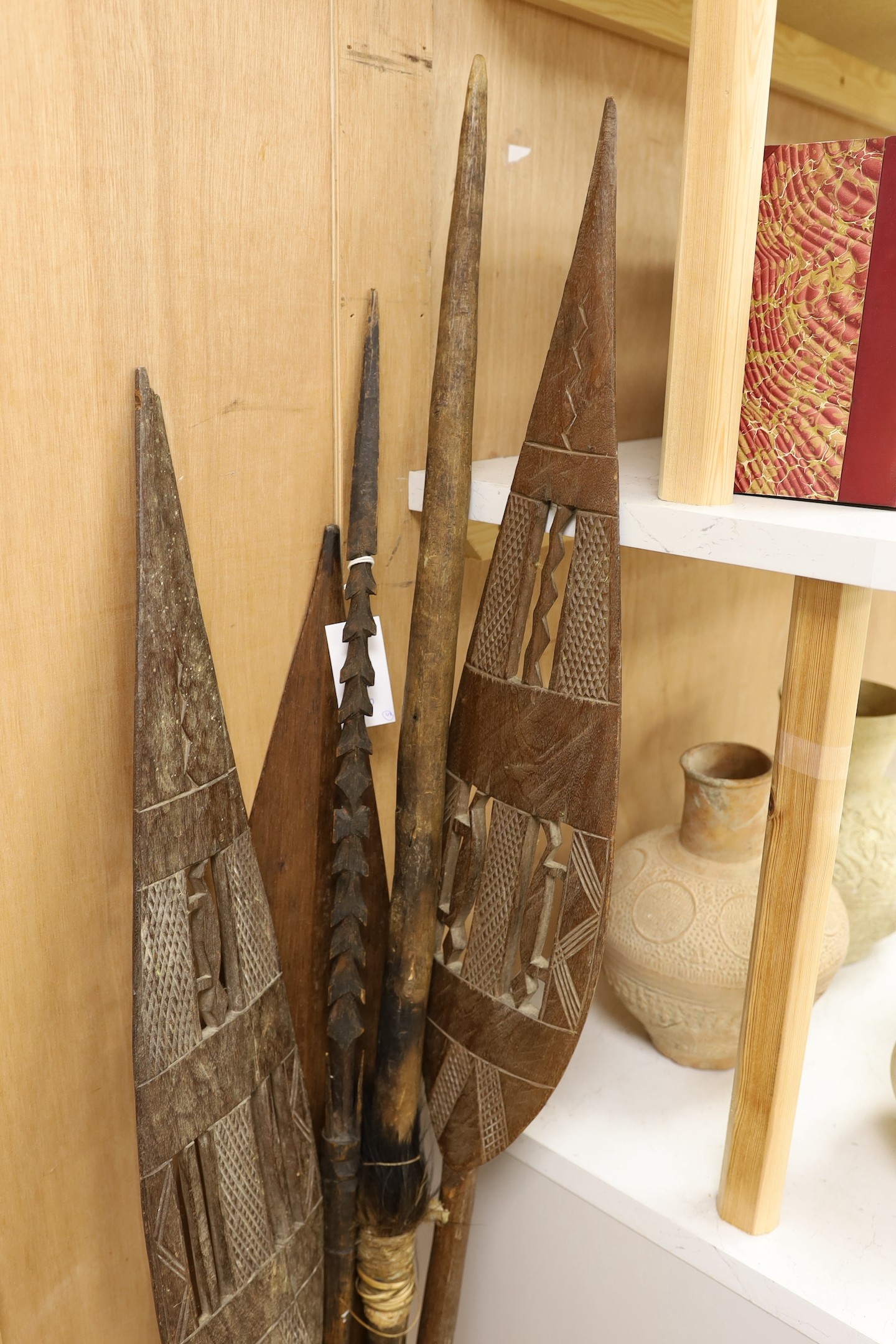 A Dayak spear paddle and four Papua New Guinea spears